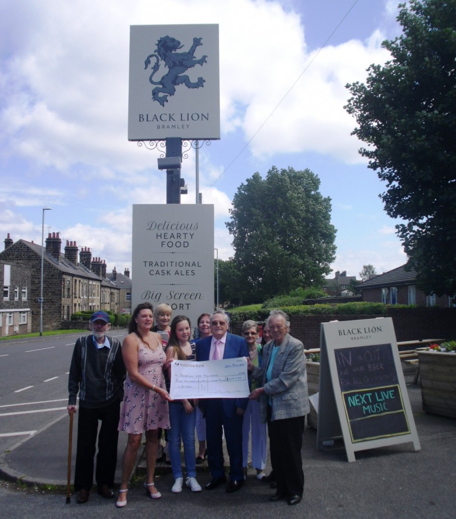 Landlady Marsha Jones and customers presenting the Cheque